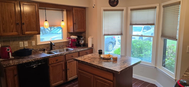 kitchen featuring sink, black dishwasher, a healthy amount of sunlight, and decorative backsplash