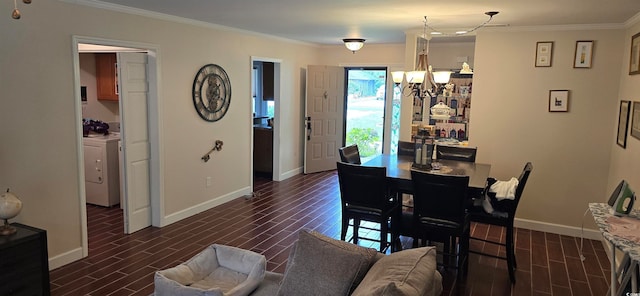 dining room with washer / dryer, a notable chandelier, and ornamental molding