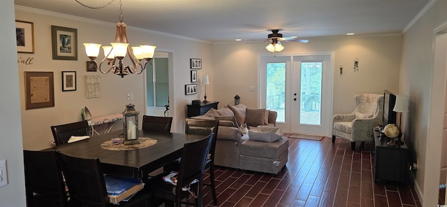 dining space with ornamental molding, ceiling fan with notable chandelier, and french doors