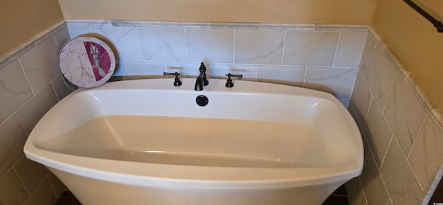 interior space featuring tile walls and a washtub