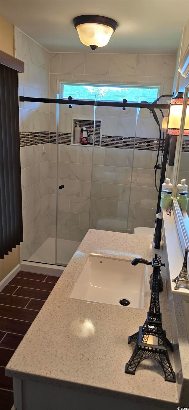 bathroom featuring walk in shower, tile patterned floors, and vanity