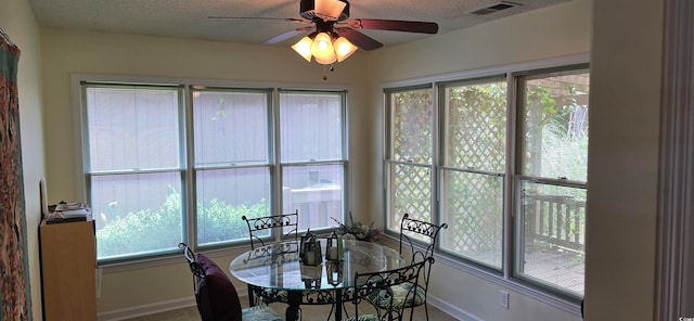 dining area featuring a textured ceiling and ceiling fan