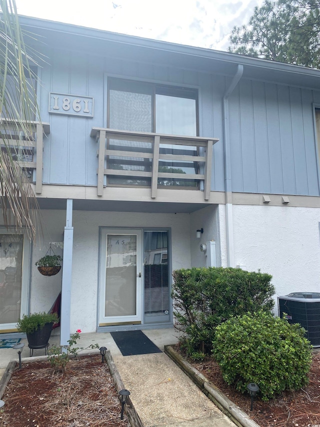 entrance to property featuring central AC unit and a balcony