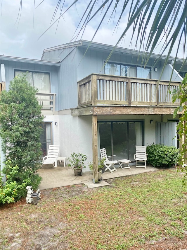 rear view of property with a balcony and a patio