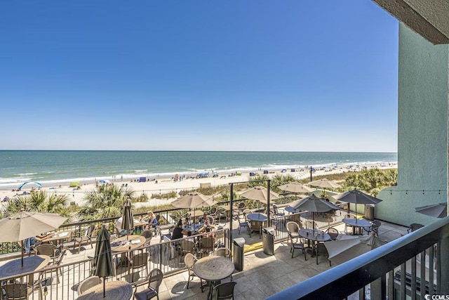 balcony with a water view and a beach view