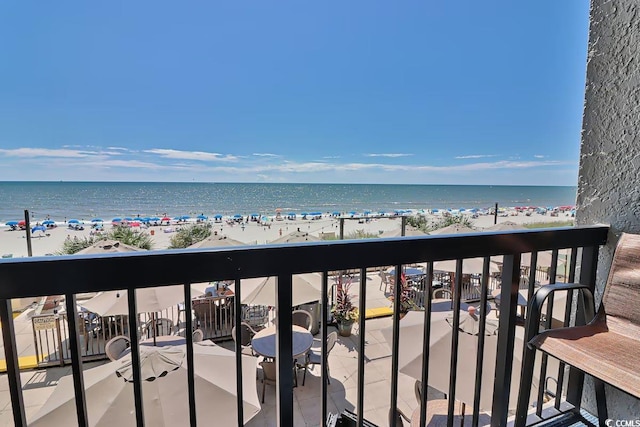 exterior space featuring a beach view and a water view