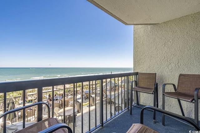 balcony featuring a water view and a view of the beach