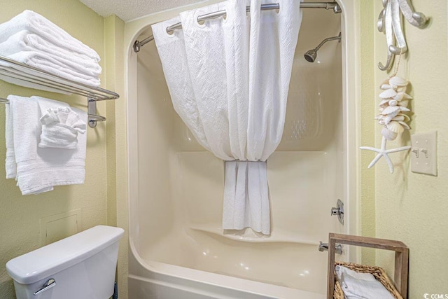 bathroom with walk in shower, a textured ceiling, and toilet