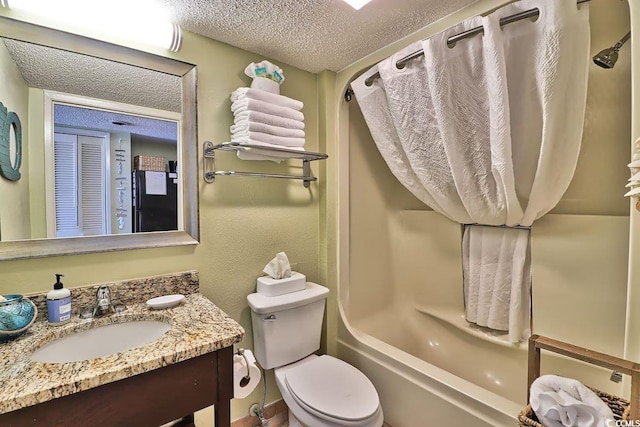 full bathroom featuring vanity, toilet, shower / bathing tub combination, and a textured ceiling