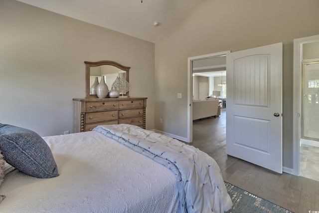 bedroom featuring hardwood / wood-style flooring and lofted ceiling