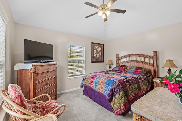 bedroom featuring light colored carpet, vaulted ceiling, and ceiling fan