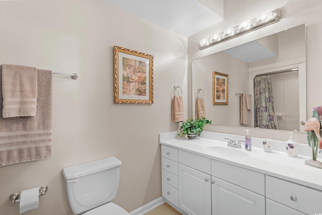 bathroom with a shower with shower curtain, a textured ceiling, vanity, and toilet