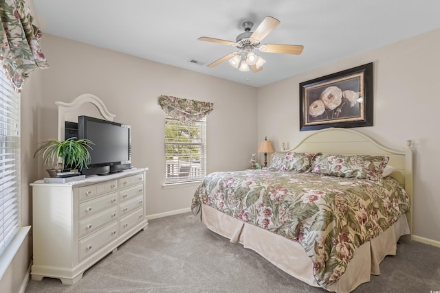 bedroom with ceiling fan and light carpet