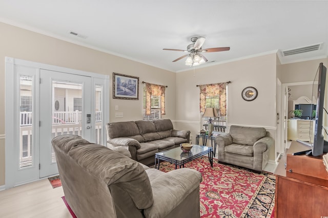 living room with light hardwood / wood-style flooring, ceiling fan, and ornamental molding