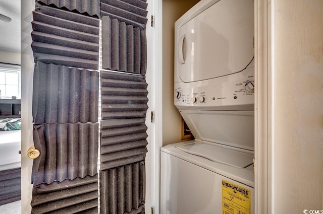 laundry area with stacked washer and dryer