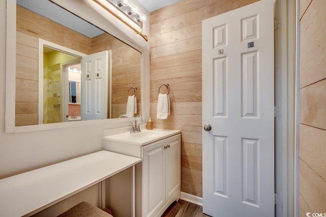 bathroom featuring vanity and wood walls