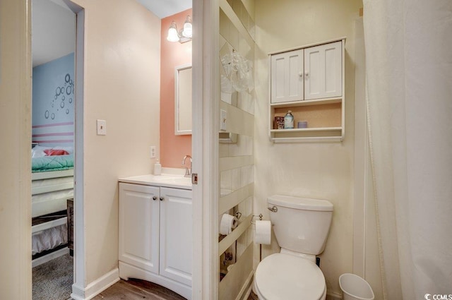 bathroom featuring vanity, wood-type flooring, and toilet