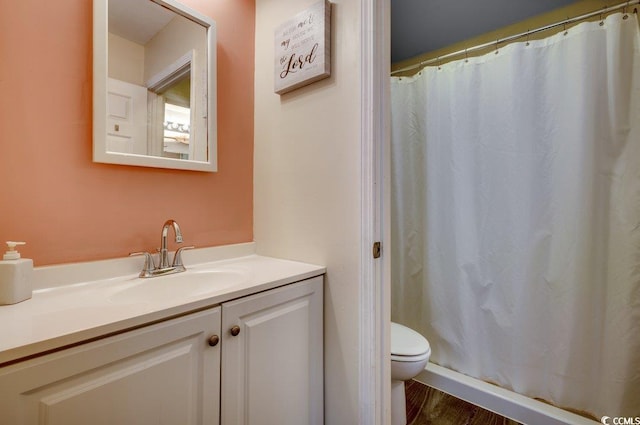 bathroom featuring vanity, hardwood / wood-style floors, and toilet