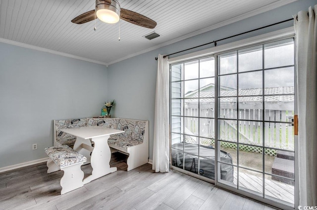 dining room with hardwood / wood-style flooring, ornamental molding, and ceiling fan