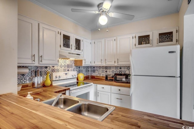 kitchen featuring white cabinets, sink, wooden counters, and white appliances