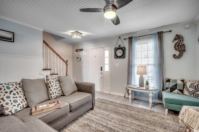 living room with hardwood / wood-style flooring, ceiling fan, and ornamental molding