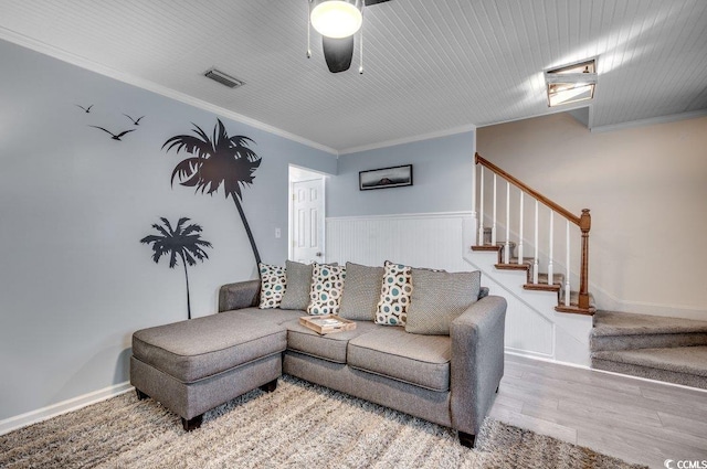 living room featuring ceiling fan, ornamental molding, and light hardwood / wood-style floors