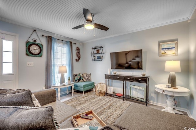 living room with ceiling fan and ornamental molding