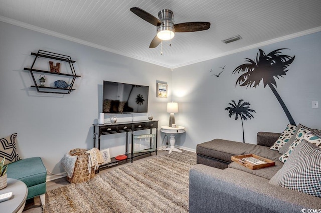 living room with ceiling fan and ornamental molding