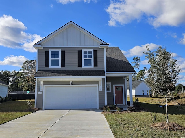 view of front of property with a front yard and a garage