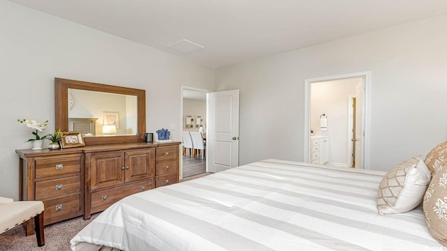 carpeted bedroom featuring ensuite bathroom