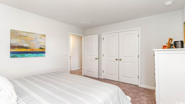 carpeted bedroom featuring a closet