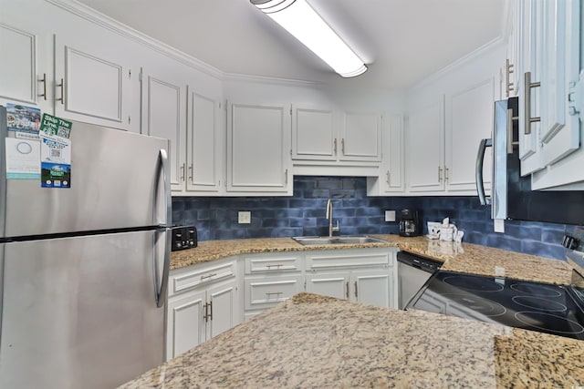 kitchen with tasteful backsplash, white cabinetry, stainless steel appliances, and a sink