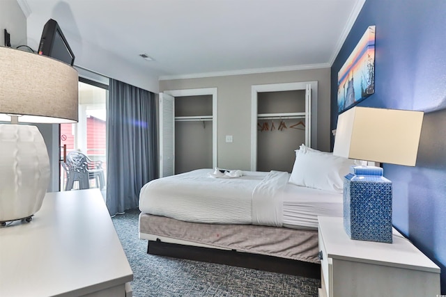 bedroom with crown molding, multiple closets, and visible vents
