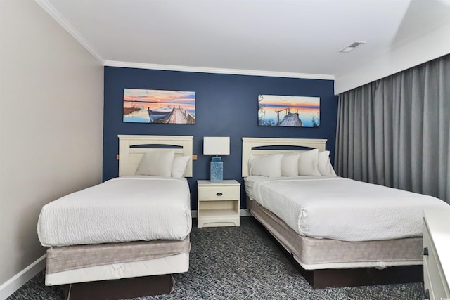 bedroom featuring visible vents, crown molding, and baseboards
