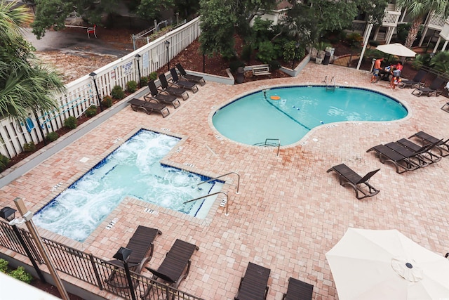 pool with fence and a patio