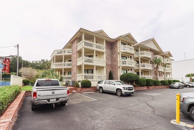 view of property featuring uncovered parking