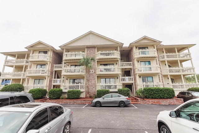 view of property with uncovered parking