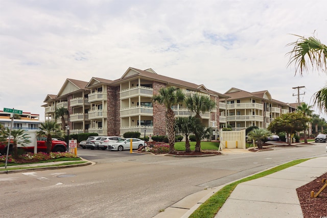 view of building exterior featuring uncovered parking