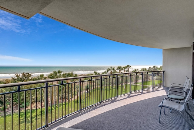 balcony featuring a water view and a beach view