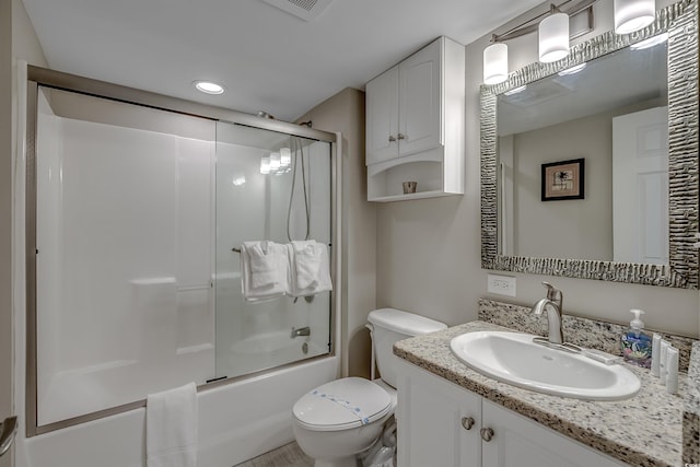 full bathroom featuring enclosed tub / shower combo, vanity, toilet, and recessed lighting