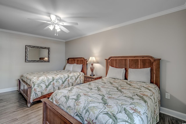 bedroom with ornamental molding, a ceiling fan, baseboards, and wood finished floors