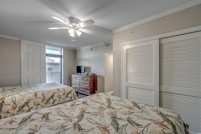 bedroom with a closet, visible vents, crown molding, and ceiling fan