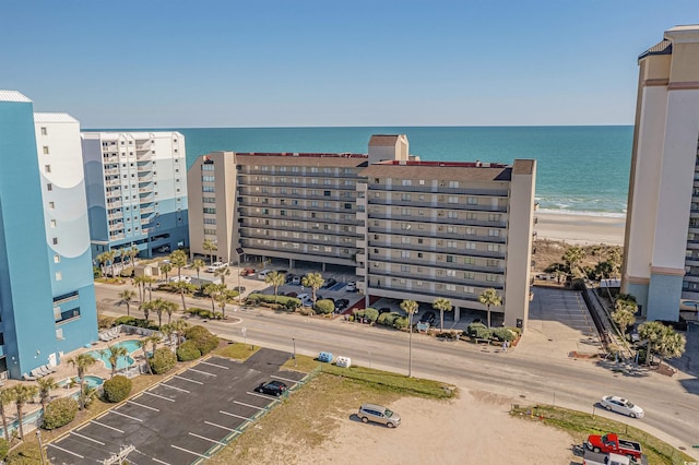 bird's eye view with a water view and a beach view