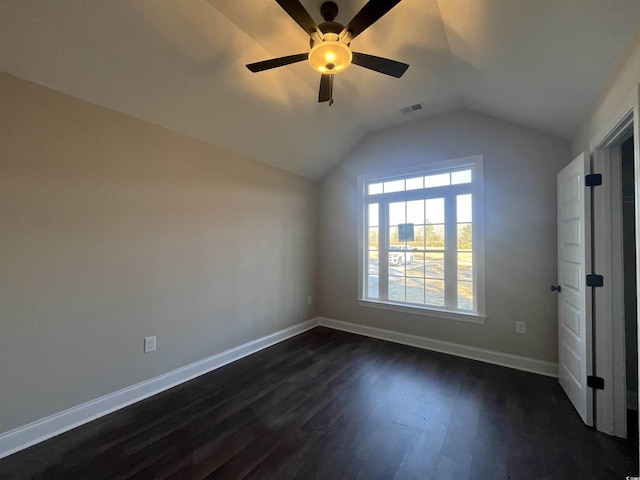 interior space with ceiling fan, lofted ceiling, and dark hardwood / wood-style flooring