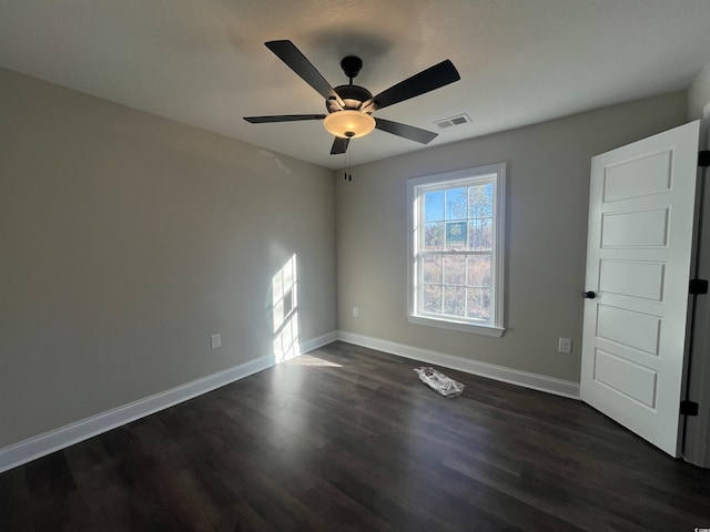 unfurnished room with ceiling fan and dark hardwood / wood-style flooring