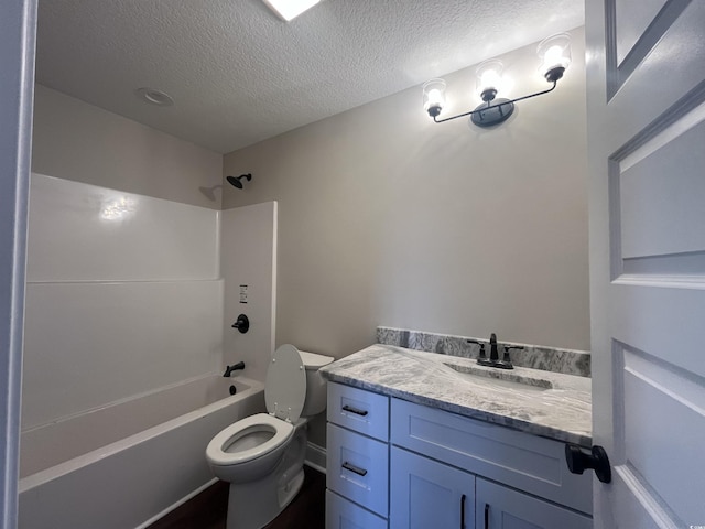 full bathroom featuring vanity, a textured ceiling, tub / shower combination, and toilet