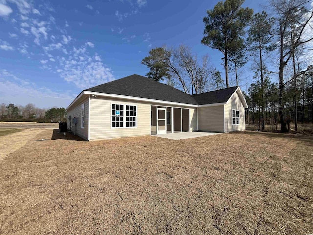 rear view of house featuring central AC, a patio area, and a lawn