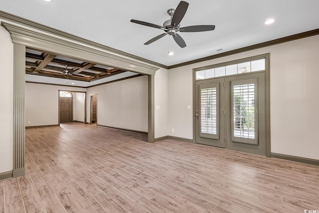 empty room with coffered ceiling, crown molding, light wood-type flooring, and ceiling fan