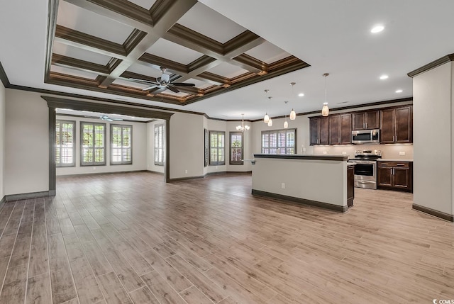 kitchen featuring appliances with stainless steel finishes, hanging light fixtures, a kitchen island, and light hardwood / wood-style floors