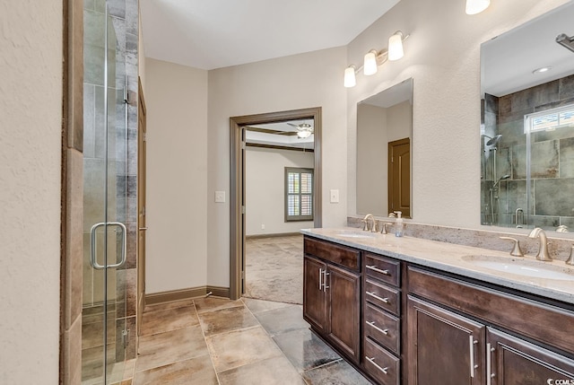 bathroom with vanity, plenty of natural light, ceiling fan, and walk in shower